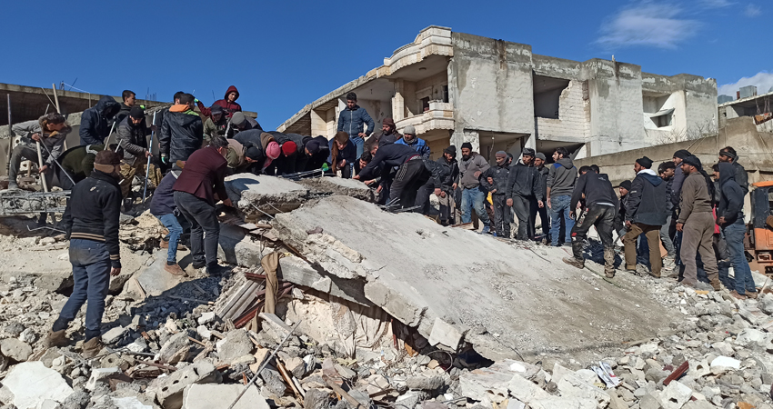 Locals trying to pull out survivors from under the debris of a collapsed building in Jindires district in rural Afrin that was hit by the 6 February 2023 earthquake. Locals are forced to help trapped persons themselves in the shadow of limited professional rescue capacities in Syria's Afrin and across the northwestern parts of the country. Credit: Local activists.