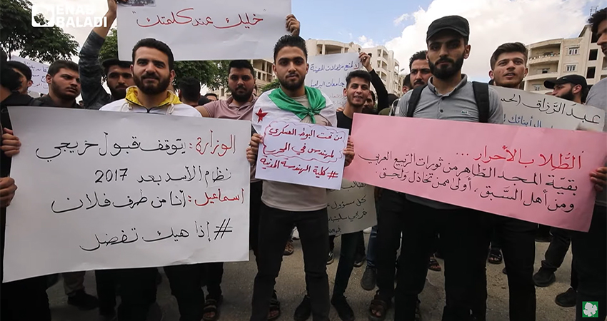 Screenshot from a video of students in Idlib, protesting the ban on recruiting Syrian government's university graduates into public and private departments in HTS-held areas. Source: Enab Baladi.